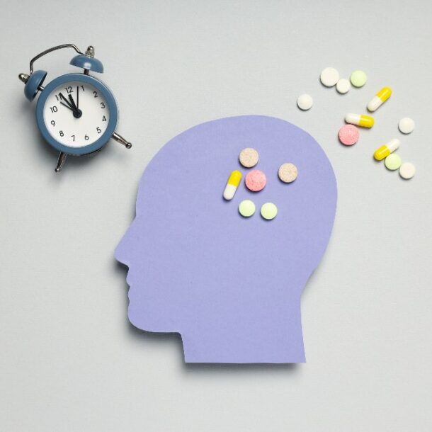 head with pills and clock