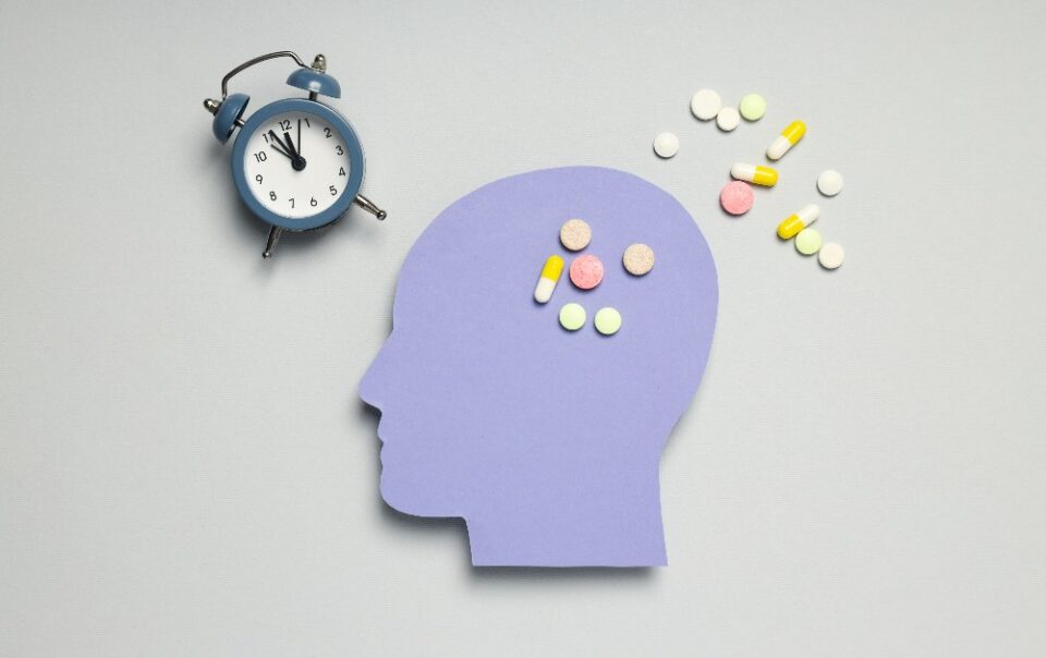 head with pills and clock