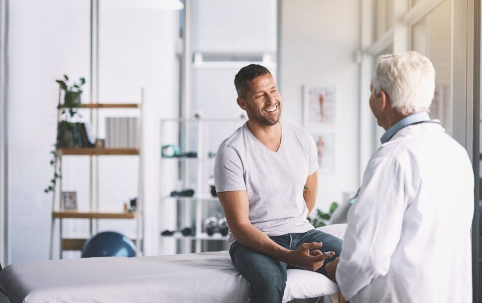 young man talking to medical professional