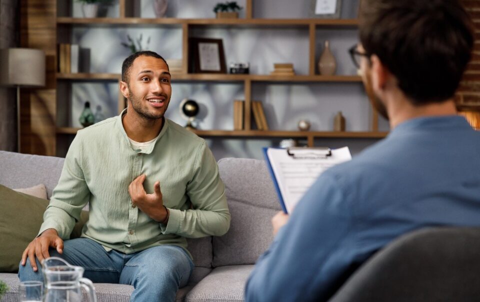 man speaking to therapist