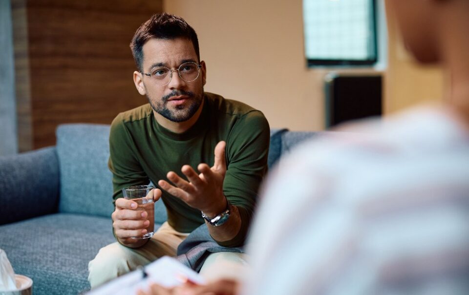 man speaking to therapist