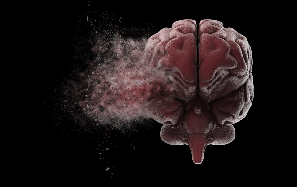 A disintegrating brain against a black background for the topic how does addiction affect the brain.
